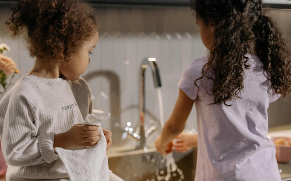 Little girls washing dishes
